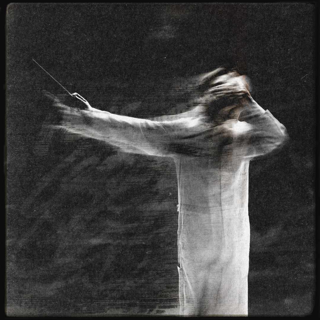 a blurry black and white photo of a conductor